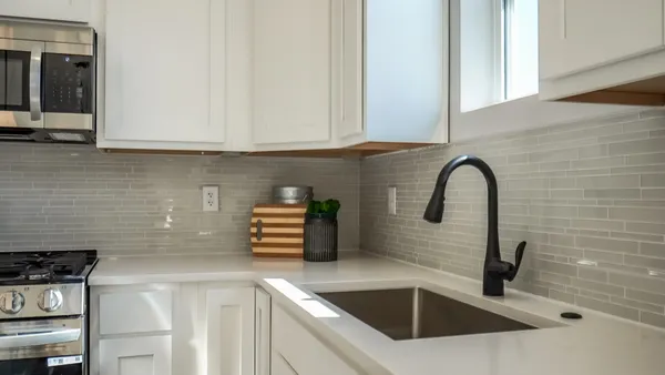 a kitchen with stainless steel appliances a stove and a microwave