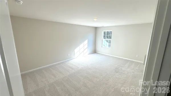 a view of an empty room and a window