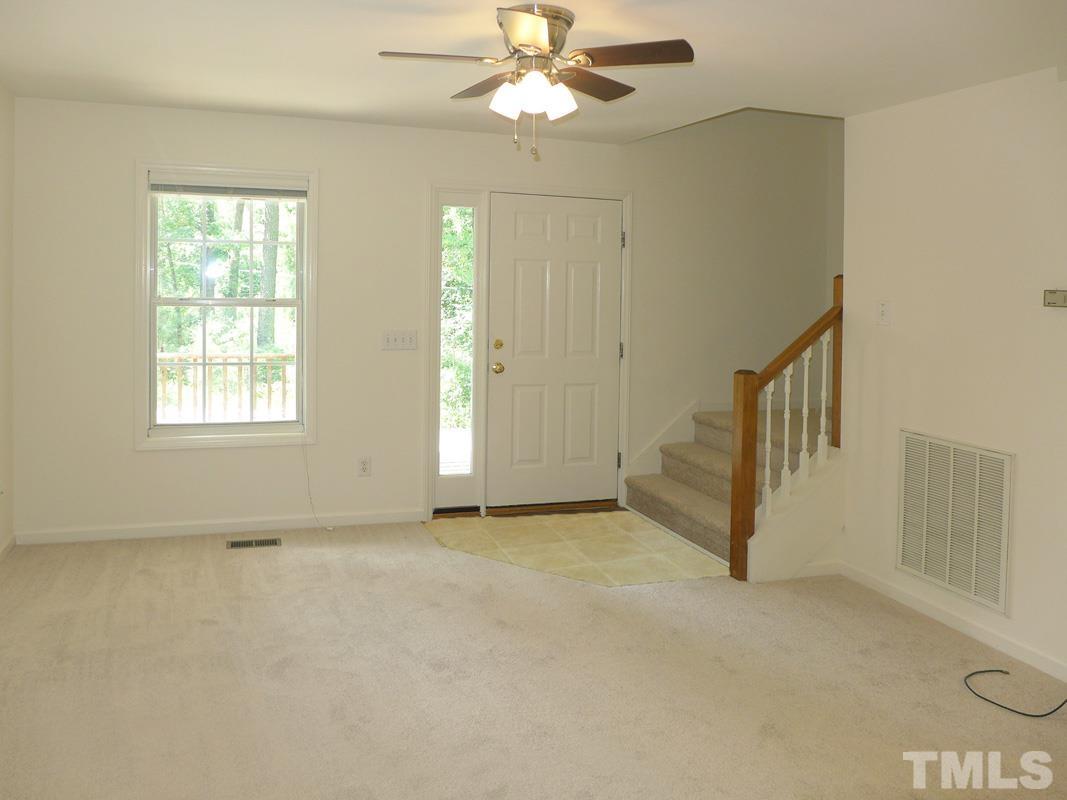 400 B W Poplar Avenue Carrboro, NC 27510 - Photo 5 of 20 an empty room with chandelier fan and windows