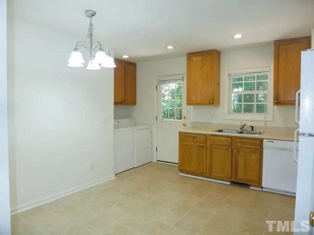 a kitchen with sink cabinets and window