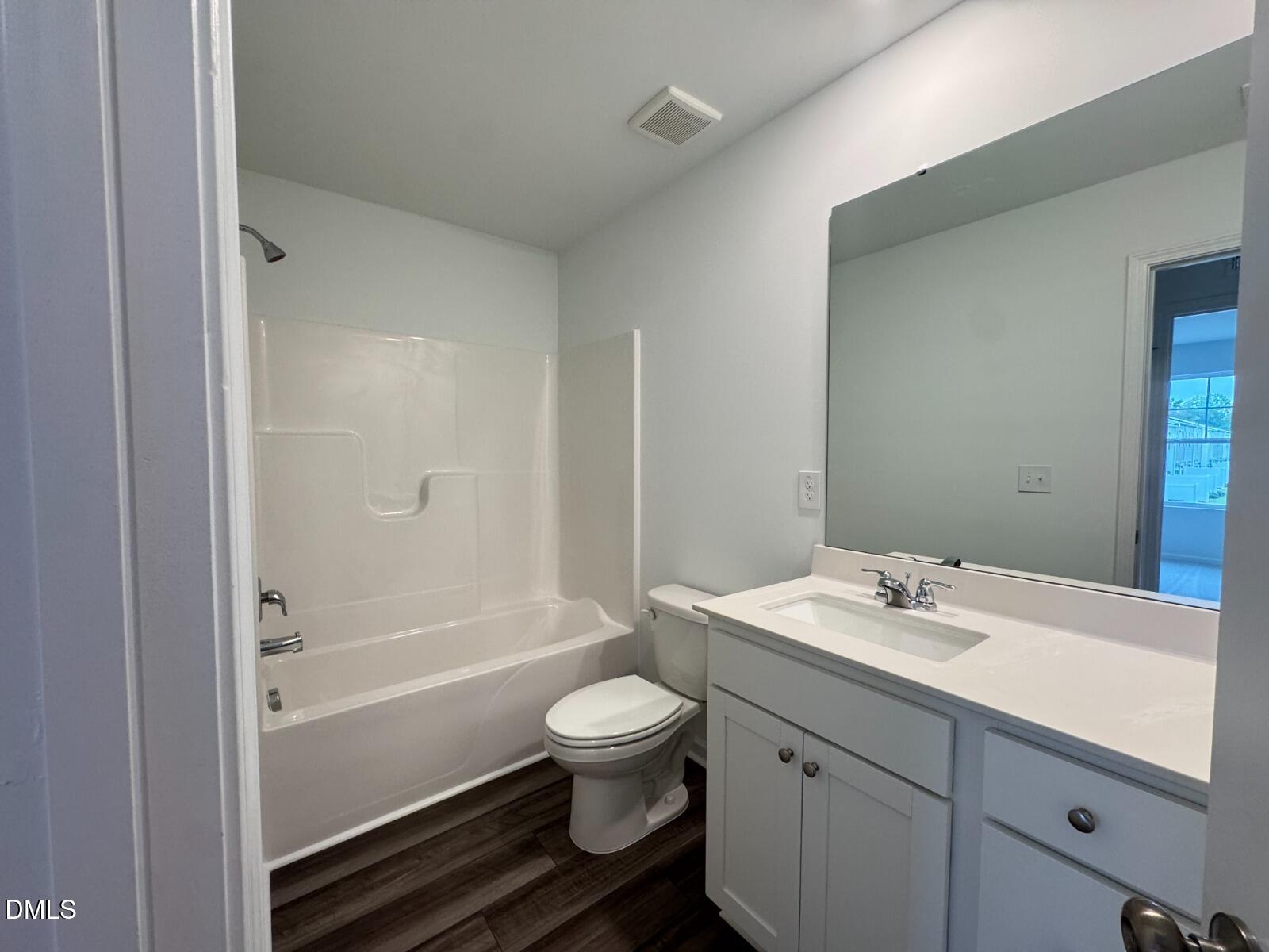 229 Lily Patch Lane Smithfield, NC 27577 - Photo 16 of 23 a bathroom with a granite countertop toilet a sink and a bathtub