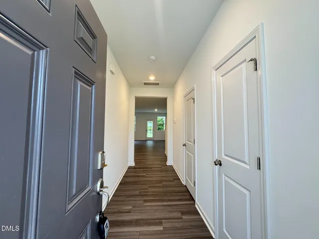 a view of a hallway with the wooden floor