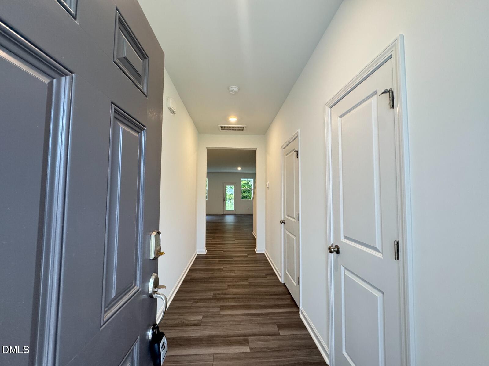 229 Lily Patch Lane Smithfield, NC 27577 - Photo 2 of 23 a view of a hallway with the wooden floor