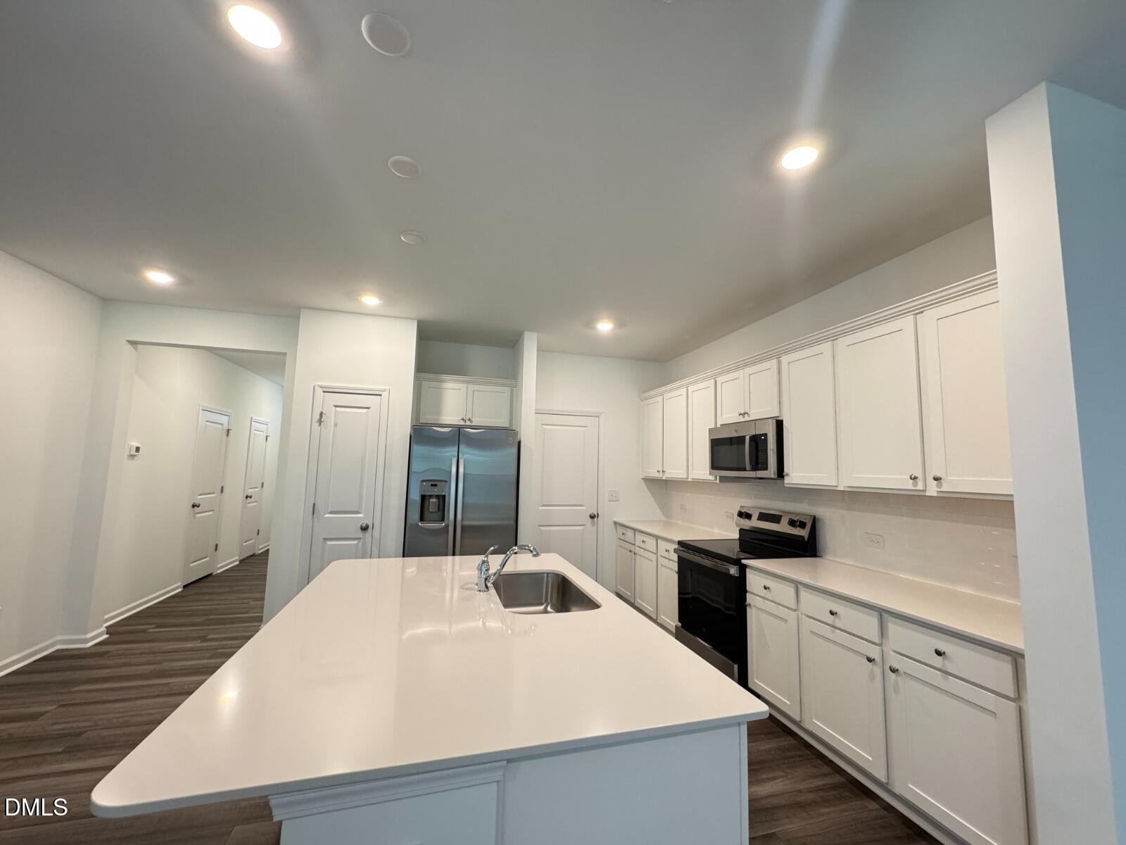 229 Lily Patch Lane Smithfield, NC 27577 - Photo 21 of 23 a large kitchen with kitchen island a sink stainless steel appliances and cabinets