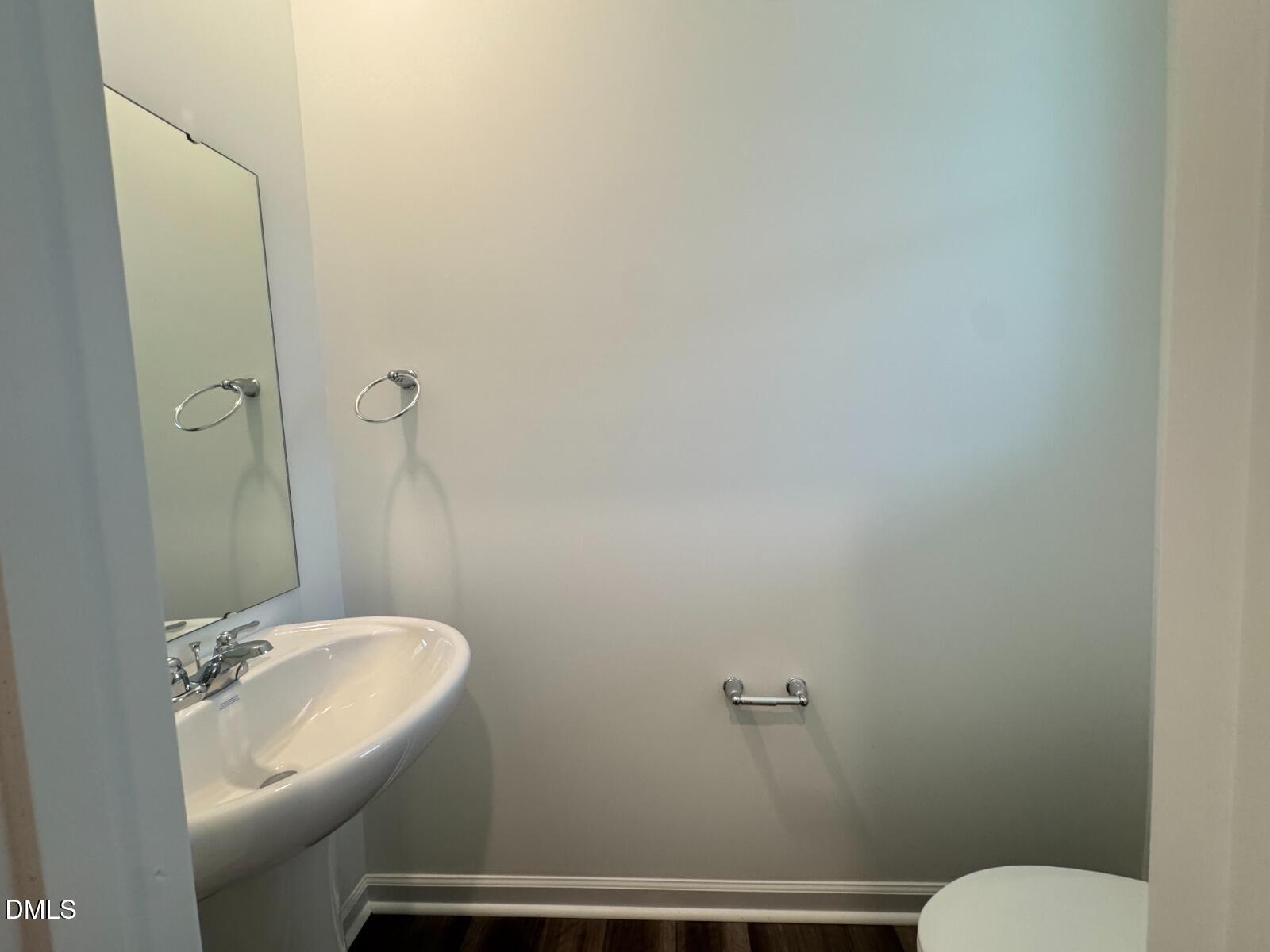 229 Lily Patch Lane Smithfield, NC 27577 - Photo 23 of 23 a bathroom with a sink mirror and toilet