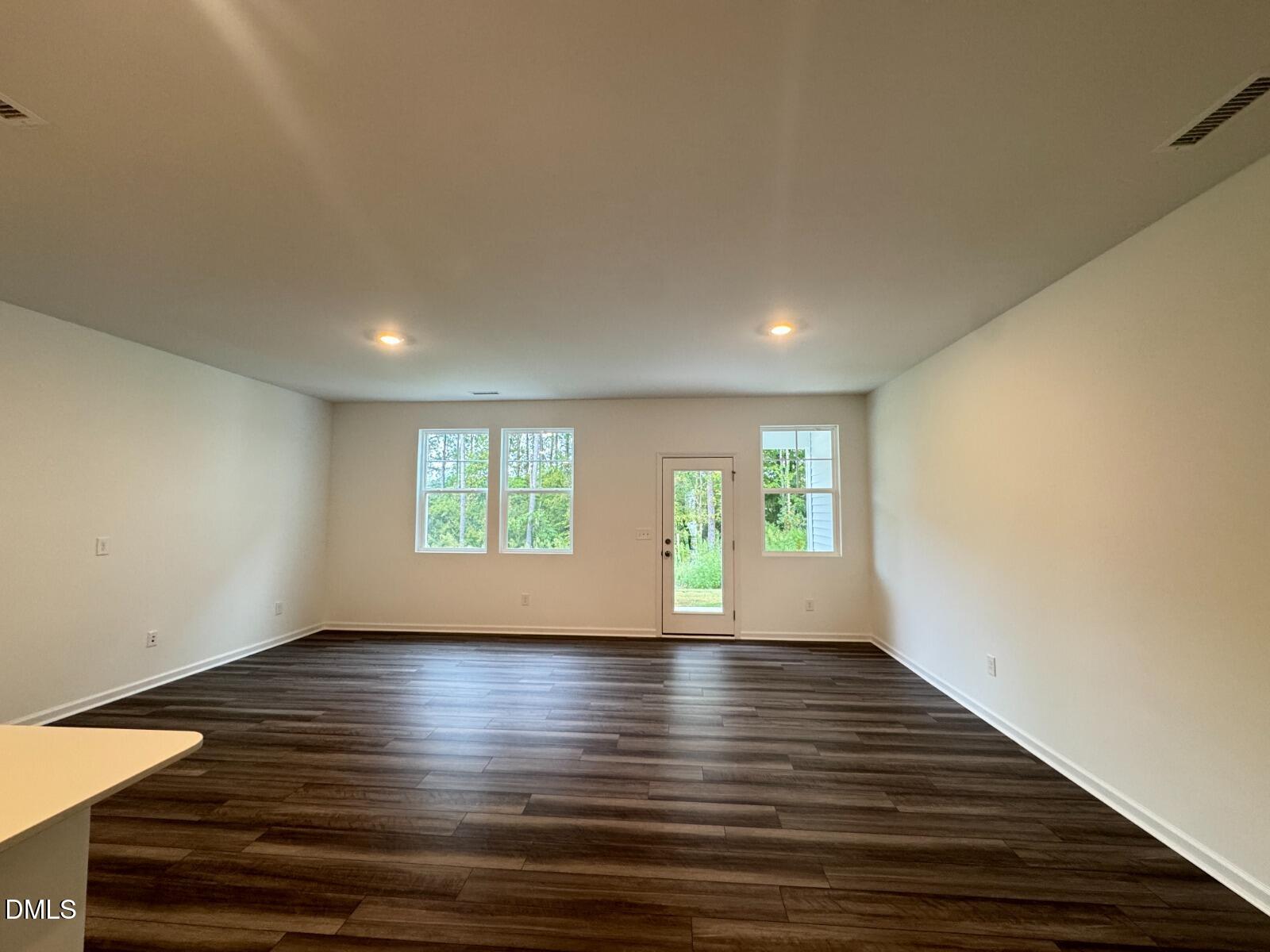 229 Lily Patch Lane Smithfield, NC 27577 - Photo 4 of 23 a view of empty room with wooden floor and fan