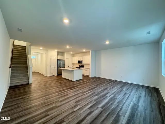 a view of a kitchen with wooden floor and a sink