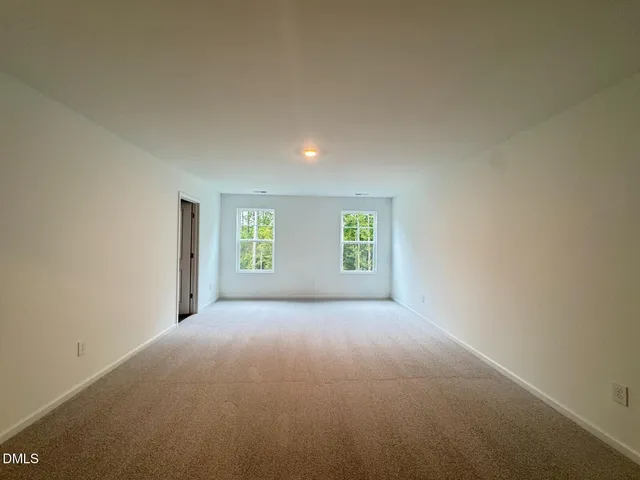 a view of a big room with windows and chandelier