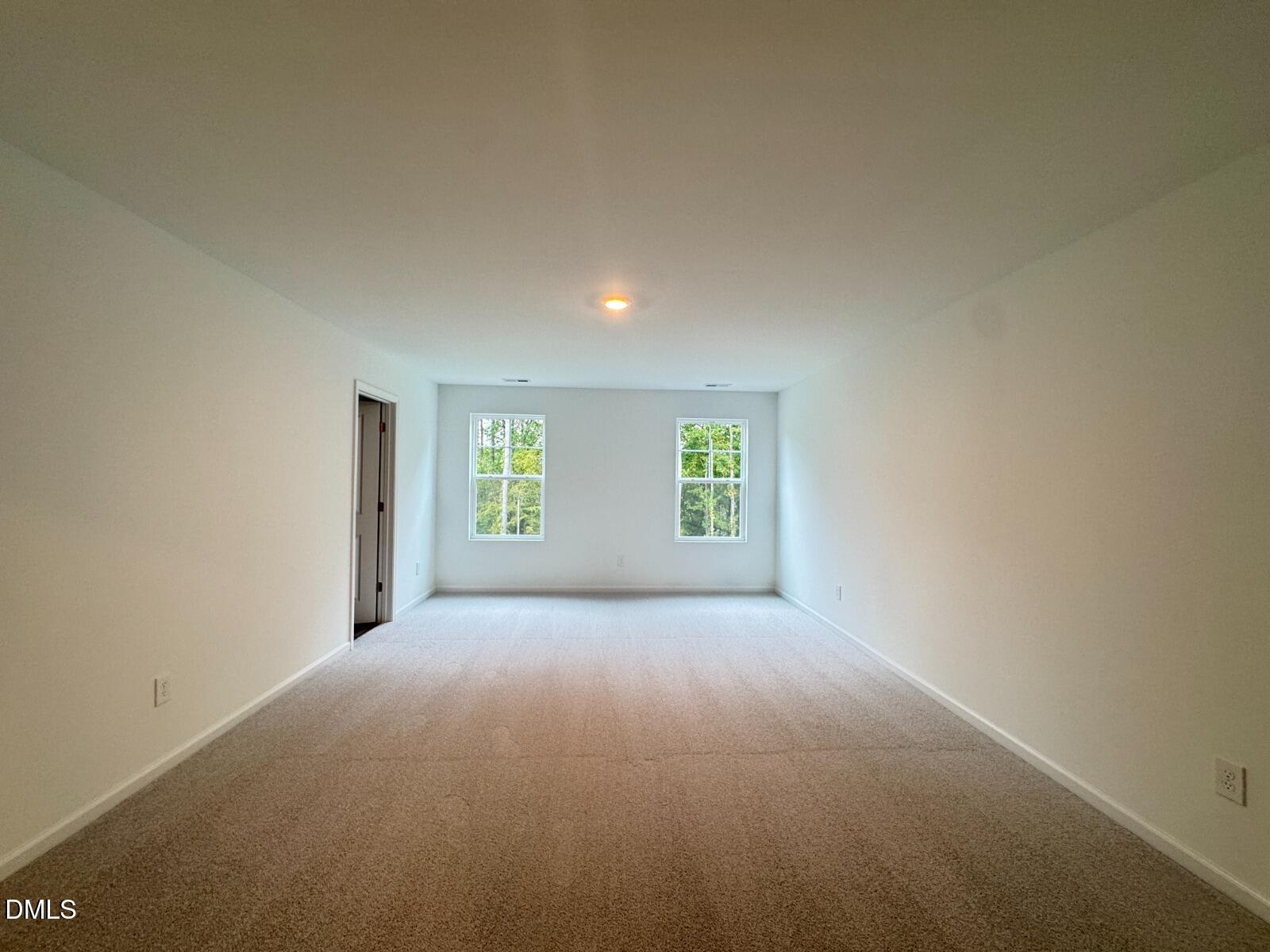 229 Lily Patch Lane Smithfield, NC 27577 - Photo 9 of 23 a view of a big room with windows and chandelier