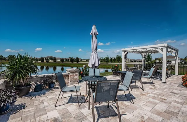 a living room with furniture kitchen view and a chandelier