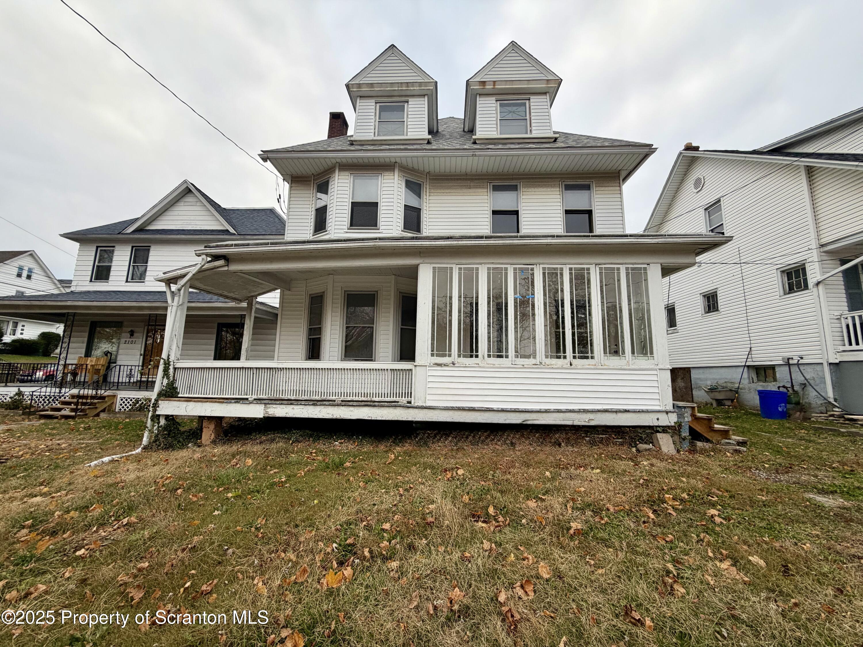 2105 Belmont Terrace, Unit 1 Scranton, PA 18508 - Photo 1 of 16 a view of a building with a large window and a chair