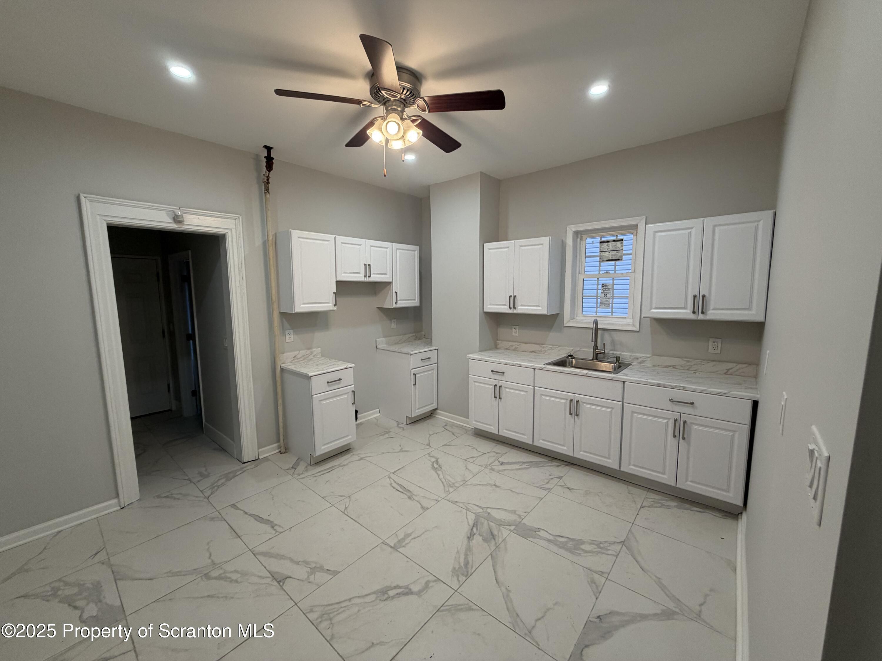 2105 Belmont Terrace, Unit 1 Scranton, PA 18508 - Photo 5 of 16 a kitchen with a sink cabinets and window