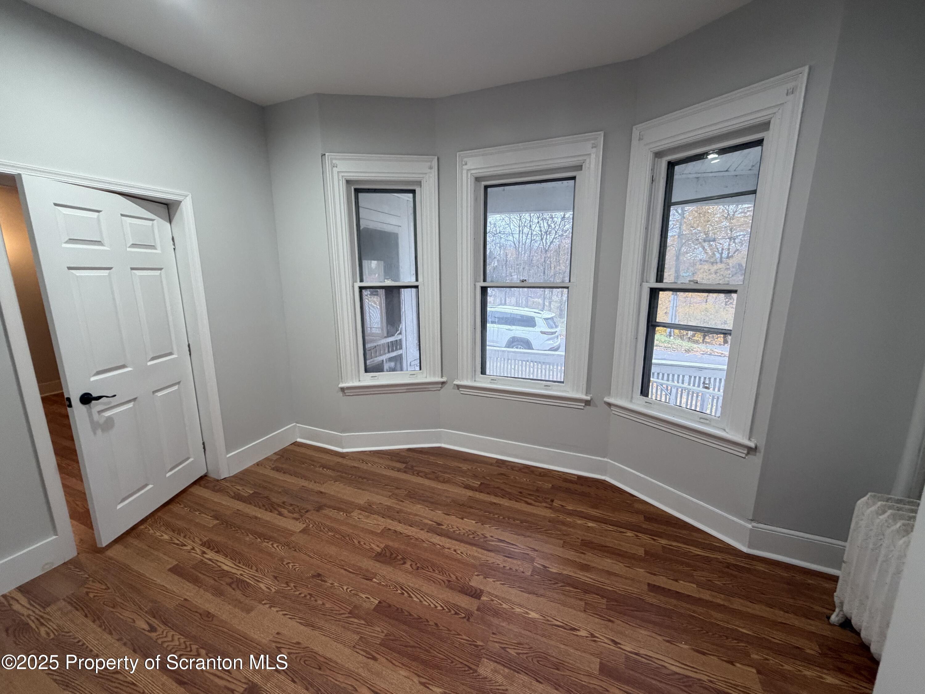 2105 Belmont Terrace, Unit 1 Scranton, PA 18508 - Photo 8 of 16 an empty room with wooden floor and windows