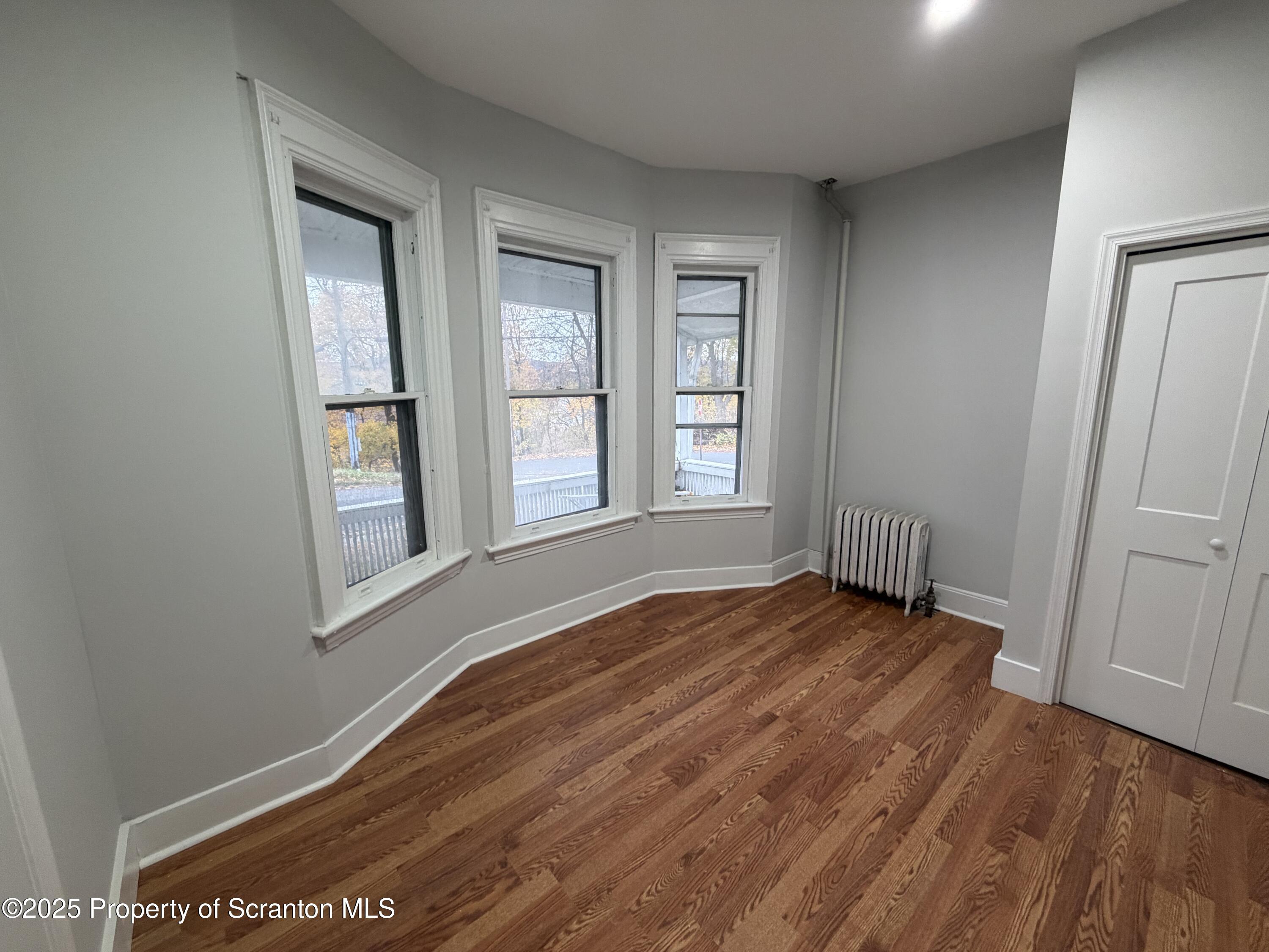 2105 Belmont Terrace, Unit 1 Scranton, PA 18508 - Photo 9 of 16 an empty room with wooden floor and windows
