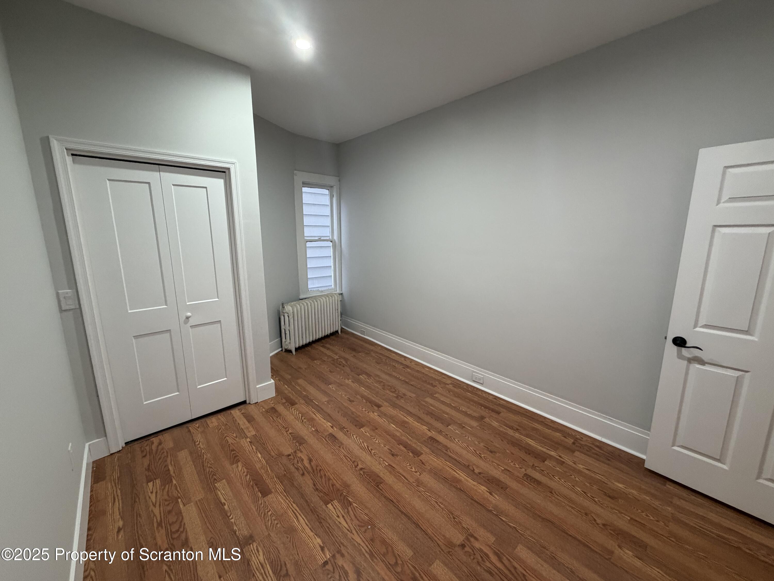 2105 Belmont Terrace, Unit 1 Scranton, PA 18508 - Photo 10 of 16 an empty room with wooden floor and closet