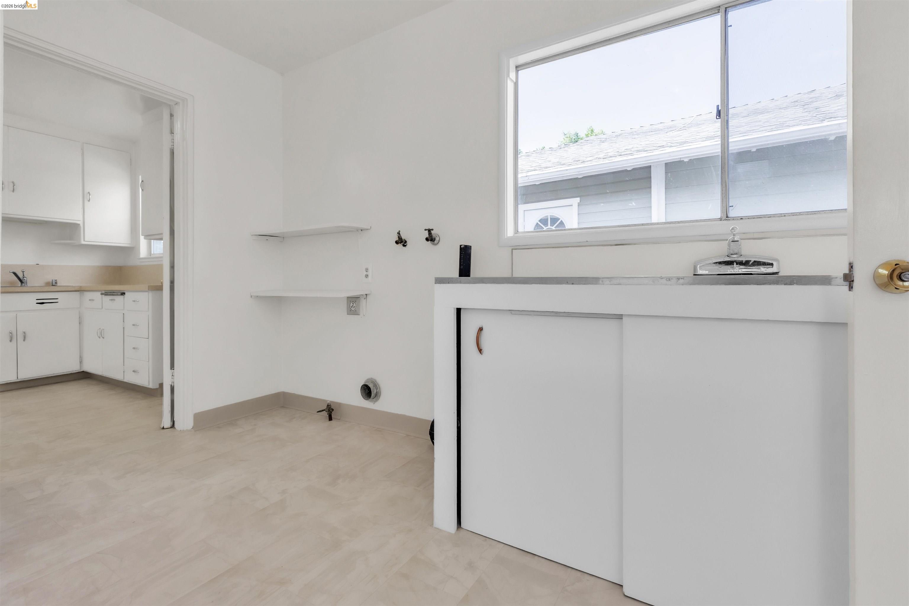 621 Paseo Del Rio San Lorenzo, CA 94580 - Photo 13 of 24 Dedicated laundry area with utility sink and storage cabinetry