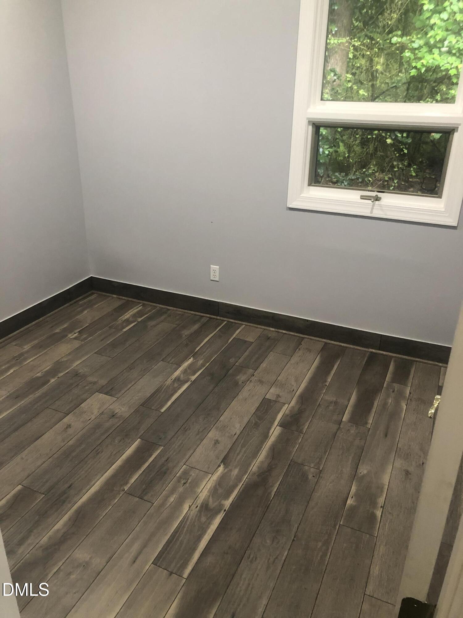 4424 Louisburg Road Raleigh, NC 27616 - Photo 16 of 17 a view of a small space with wooden floor and a window