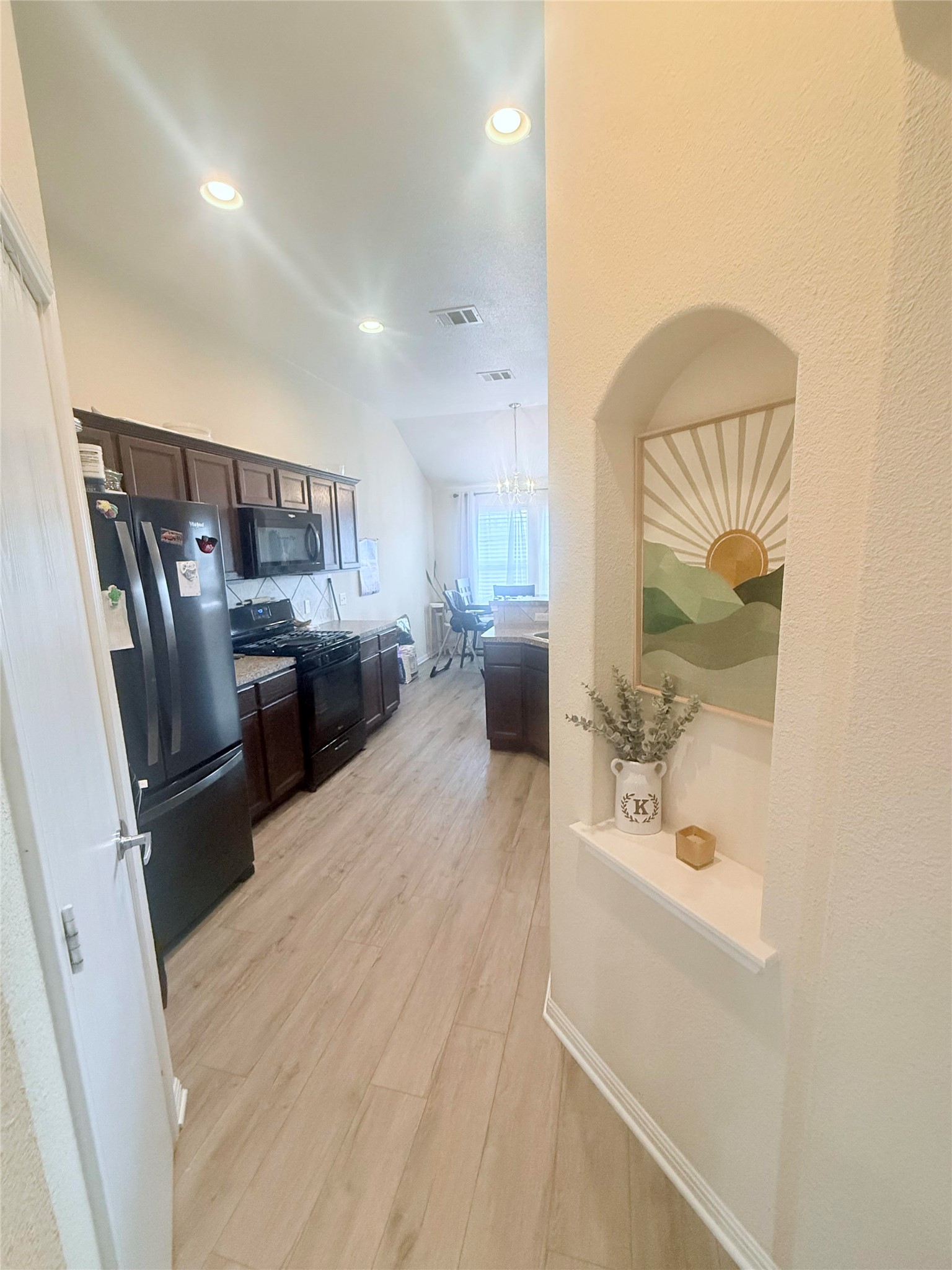 107 Jim Dandy Drive Elgin, TX 78621 - Photo 4 of 15 Recessed lighting illuminates the open-concept kitchen.