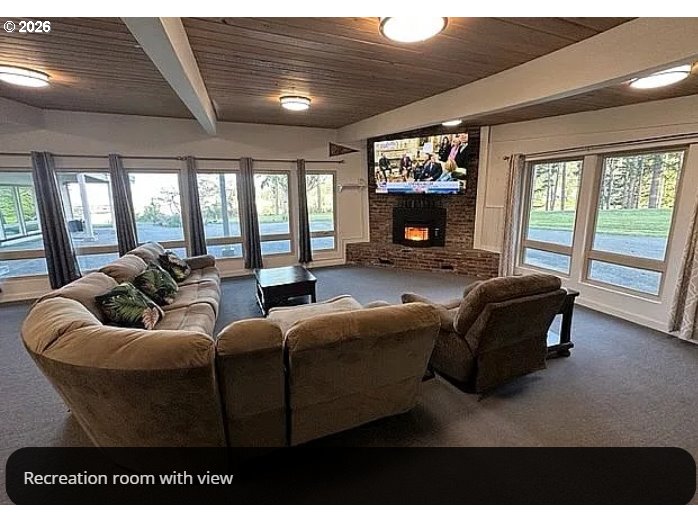 94475 Golf Course Lane North Bend, OR 97459 - Photo 12 of 45 a living room with furniture a fireplace and a large window