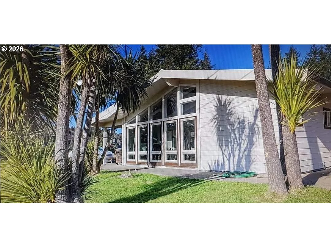 94475 Golf Course Lane North Bend, OR 97459 - Photo 3 of 45 a front view of a house with garden