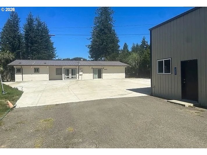 94475 Golf Course Lane North Bend, OR 97459 - Photo 5 of 45 a house with trees in the background