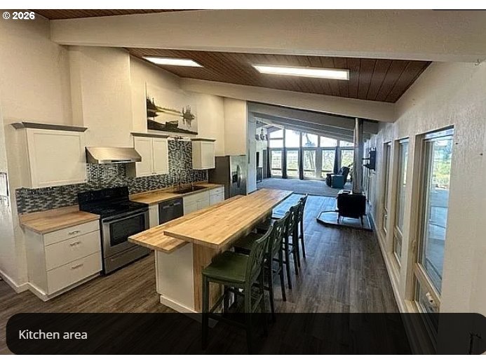 94475 Golf Course Lane North Bend, OR 97459 - Photo 8 of 45 a kitchen with a table chairs refrigerator and cabinets