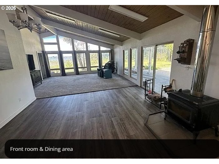 94475 Golf Course Lane North Bend, OR 97459 - Photo 10 of 45 a living room with furniture windows and a flat screen tv