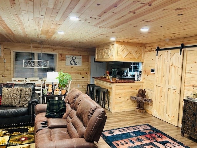 2445 McCord Hill Road Wellsburg, WV 26070 - Photo 18 of 37 Living area with a barn door, wood ceiling, wooden walls, light wood-style floors, and recessed lighting