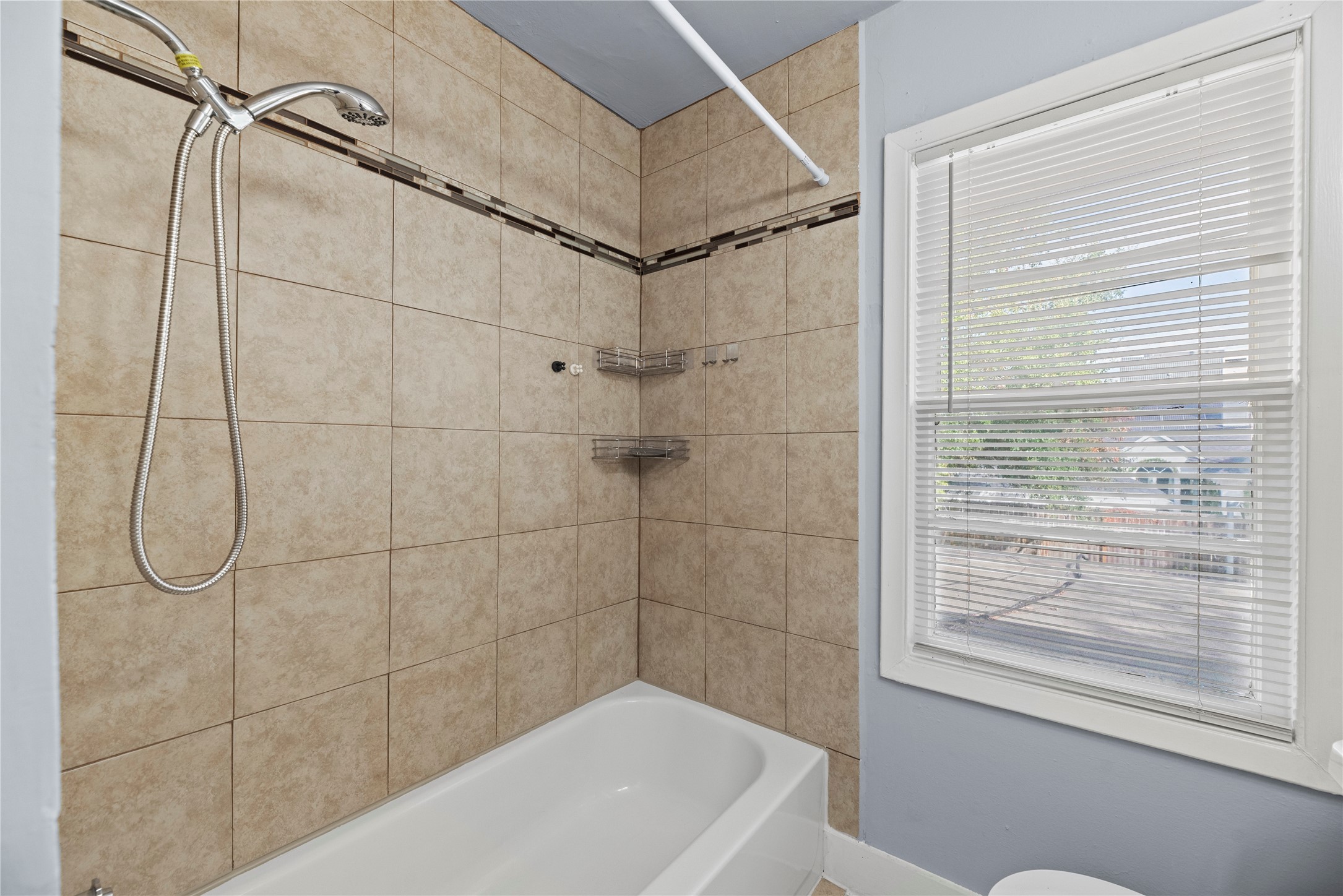 3930 Law Street, Unit 2 Houston, TX 77005 - Photo 12 of 16 a bathroom with a bath tub and shower