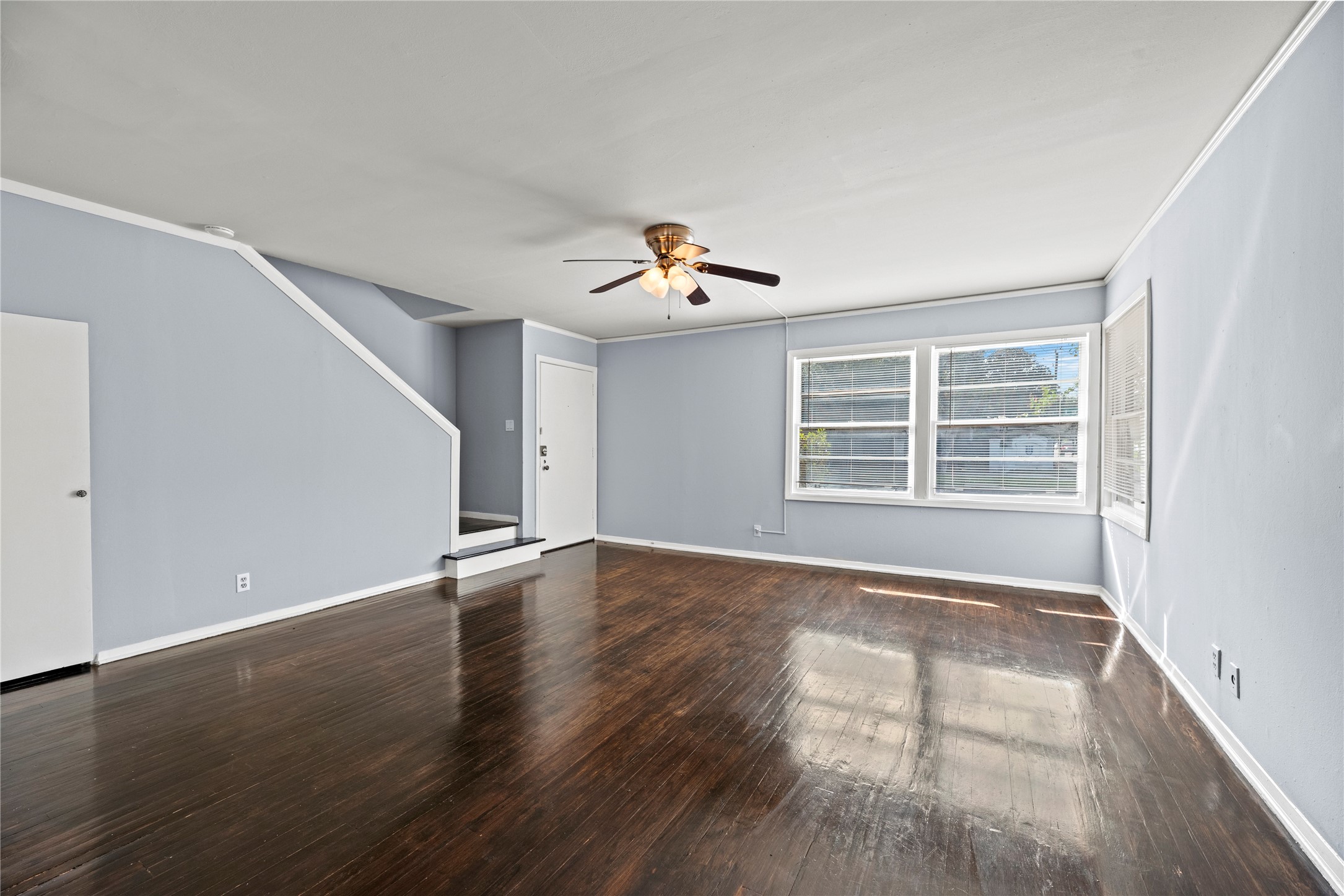 3930 Law Street, Unit 2 Houston, TX 77005 - Photo 2 of 16 a view of an empty room with wooden floor and a window