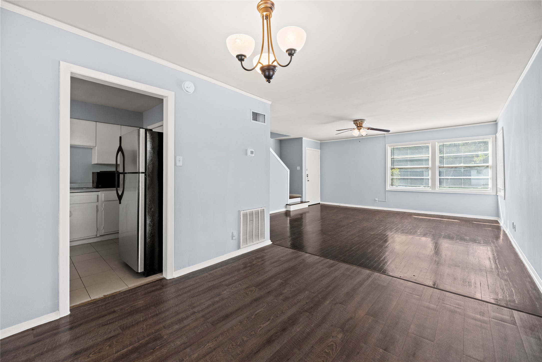 3930 Law Street, Unit 2 Houston, TX 77005 - Photo 3 of 16 an empty room with wooden floor cabinet and windows