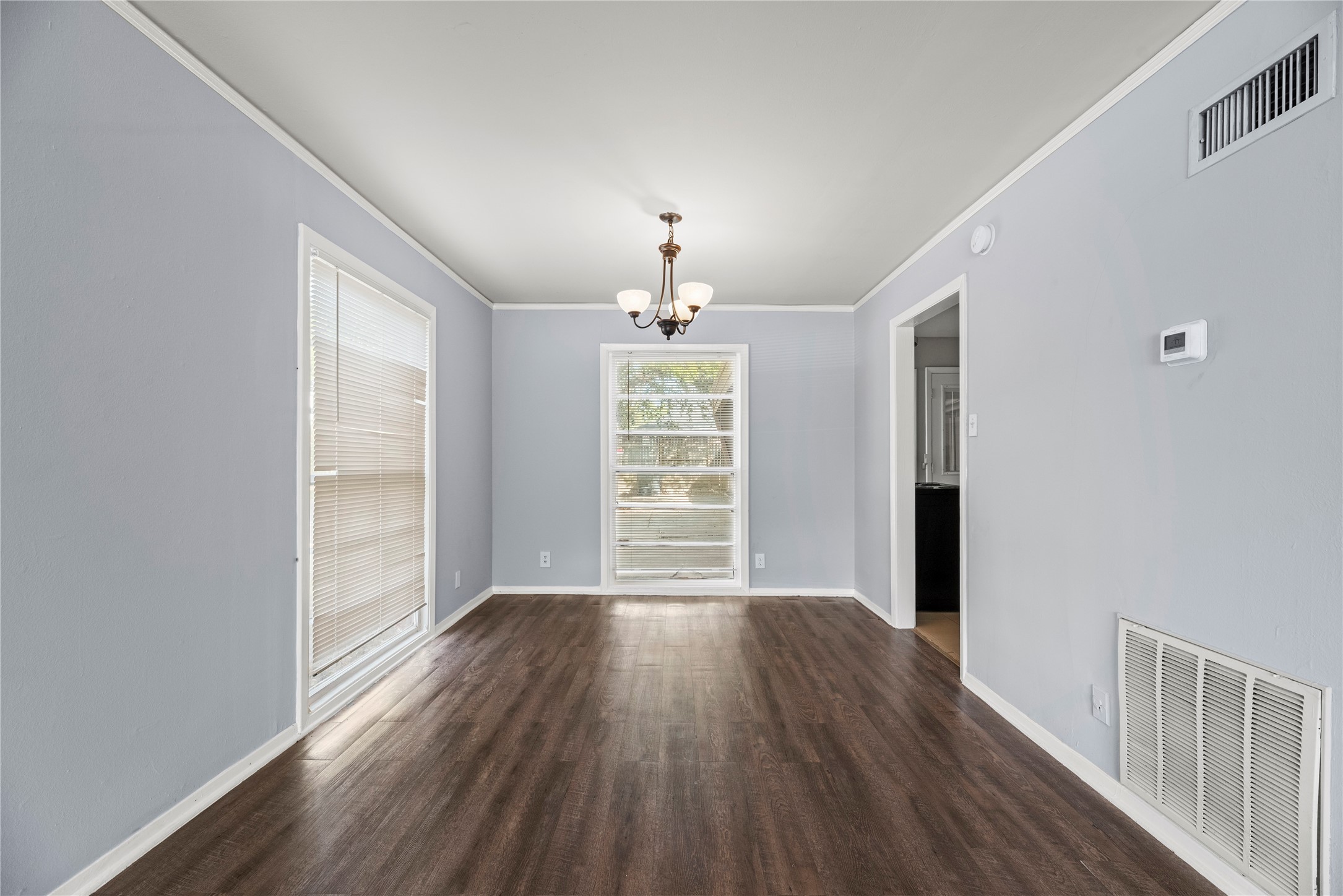 3930 Law Street, Unit 2 Houston, TX 77005 - Photo 4 of 16 a view of a room with wooden floors fan and window