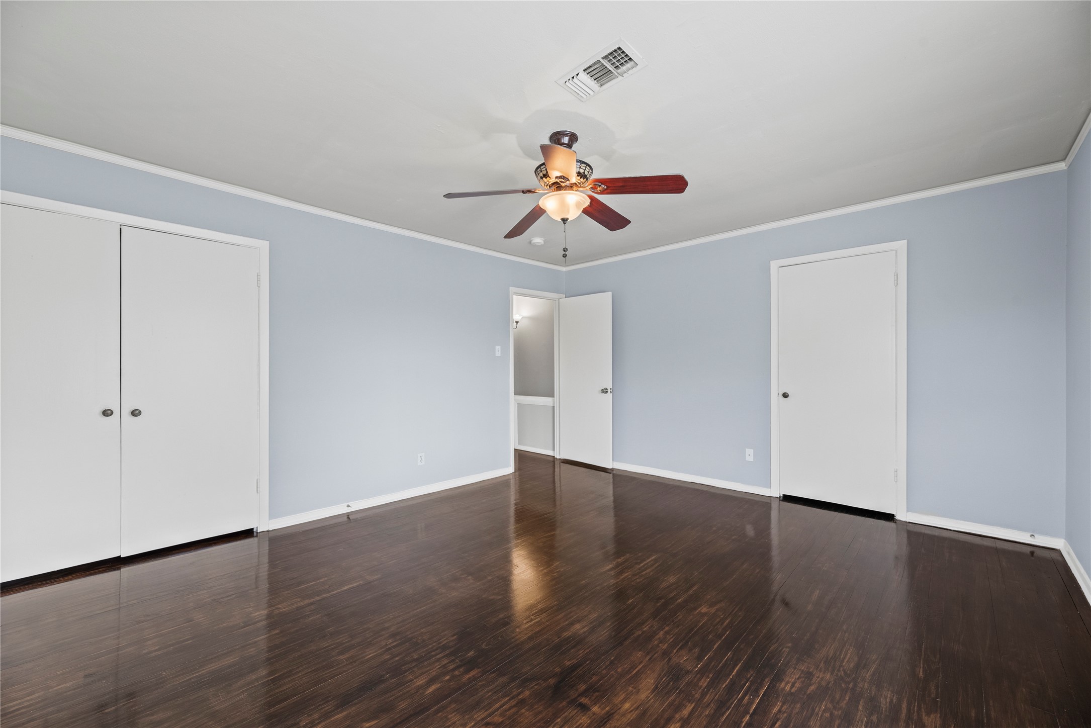 3930 Law Street, Unit 2 Houston, TX 77005 - Photo 9 of 16 a view of a room with wooden floor and ceiling fan
