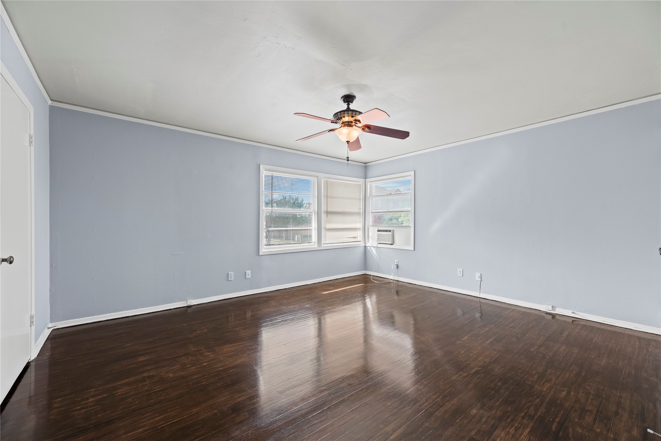 3930 Law Street, Unit 2 Houston, TX 77005 - Photo 10 of 16 a view of an empty room with wooden floor and a window