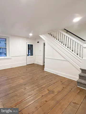 a view of an entryway with wooden floor