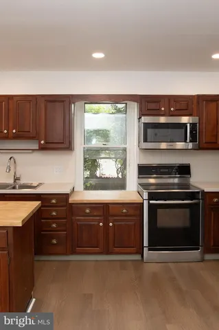 a kitchen with a sink stove and microwave