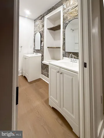 a bathroom with a sink double vanity and a mirror