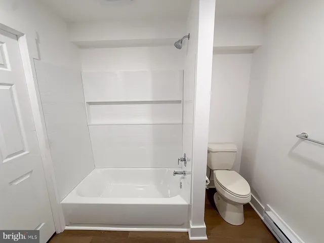 a bathroom with a toilet and a bathtub
