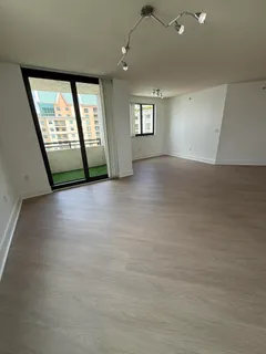 an empty room with windows and ceiling fan