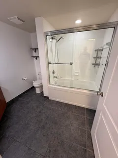 a view of walk in closet with clothes and white walls