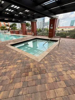 a view of a patio with plants and chairs