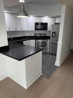 a kitchen with stainless steel appliances a microwave a sink and a stove