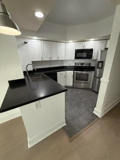 a kitchen with stainless steel appliances a sink and a stove