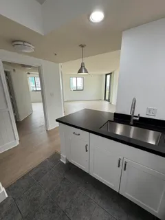 a kitchen with granite countertop a sink and cabinets