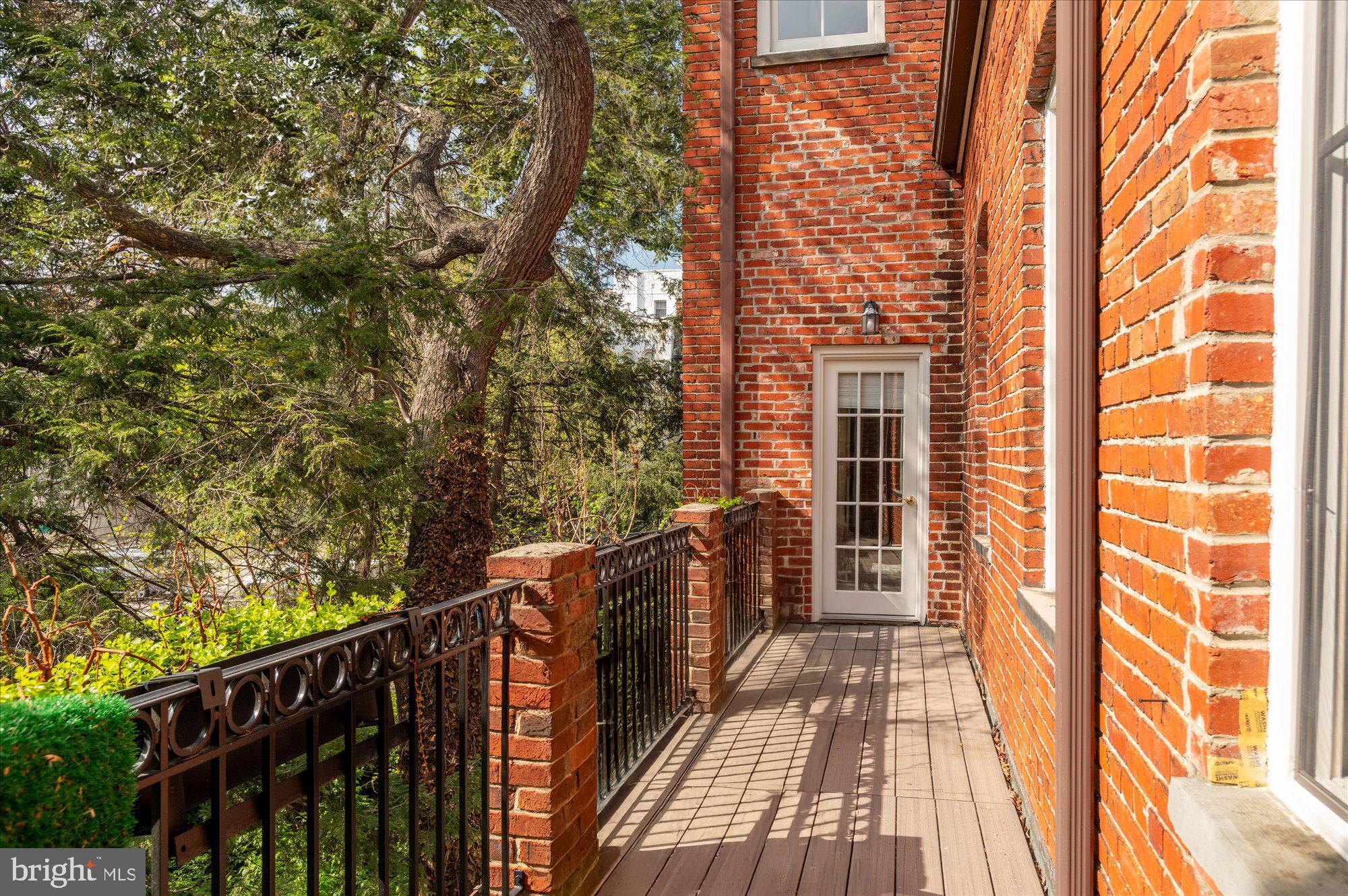 2238 Q Street Northwest Washington, DC 20008 - Photo 20 of 35 a view of balcony with wooden floor and fence