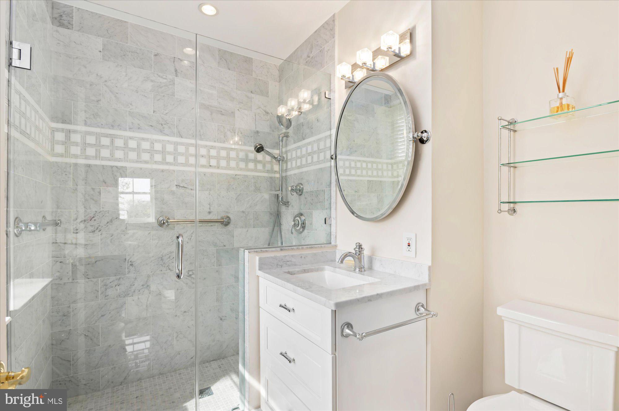 2238 Q Street Northwest Washington, DC 20008 - Photo 25 of 35 a bathroom with a sink a mirror a vanity and a shower