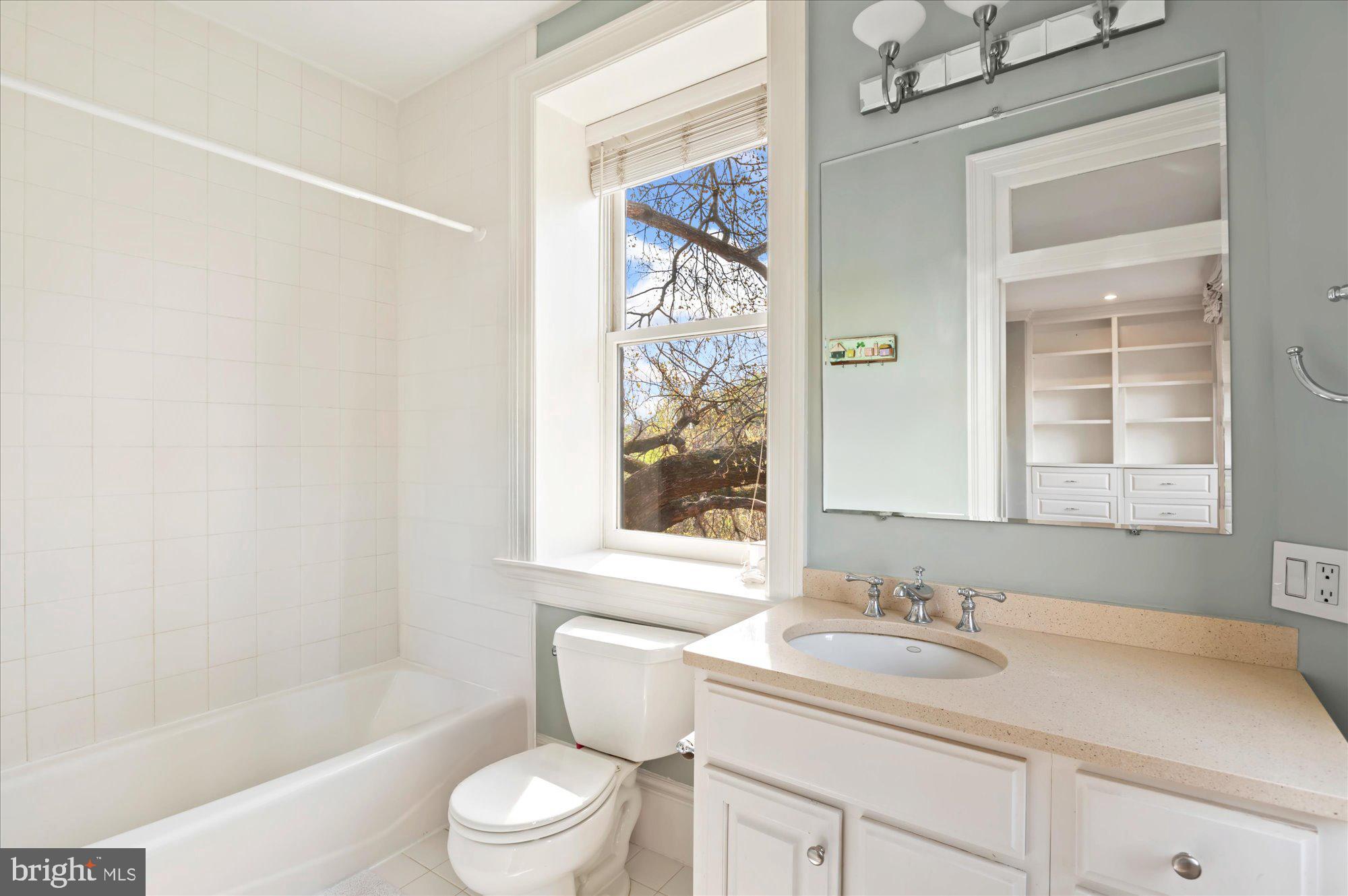 2238 Q Street Northwest Washington, DC 20008 - Photo 27 of 35 a bathroom with a granite countertop sink toilet and shower