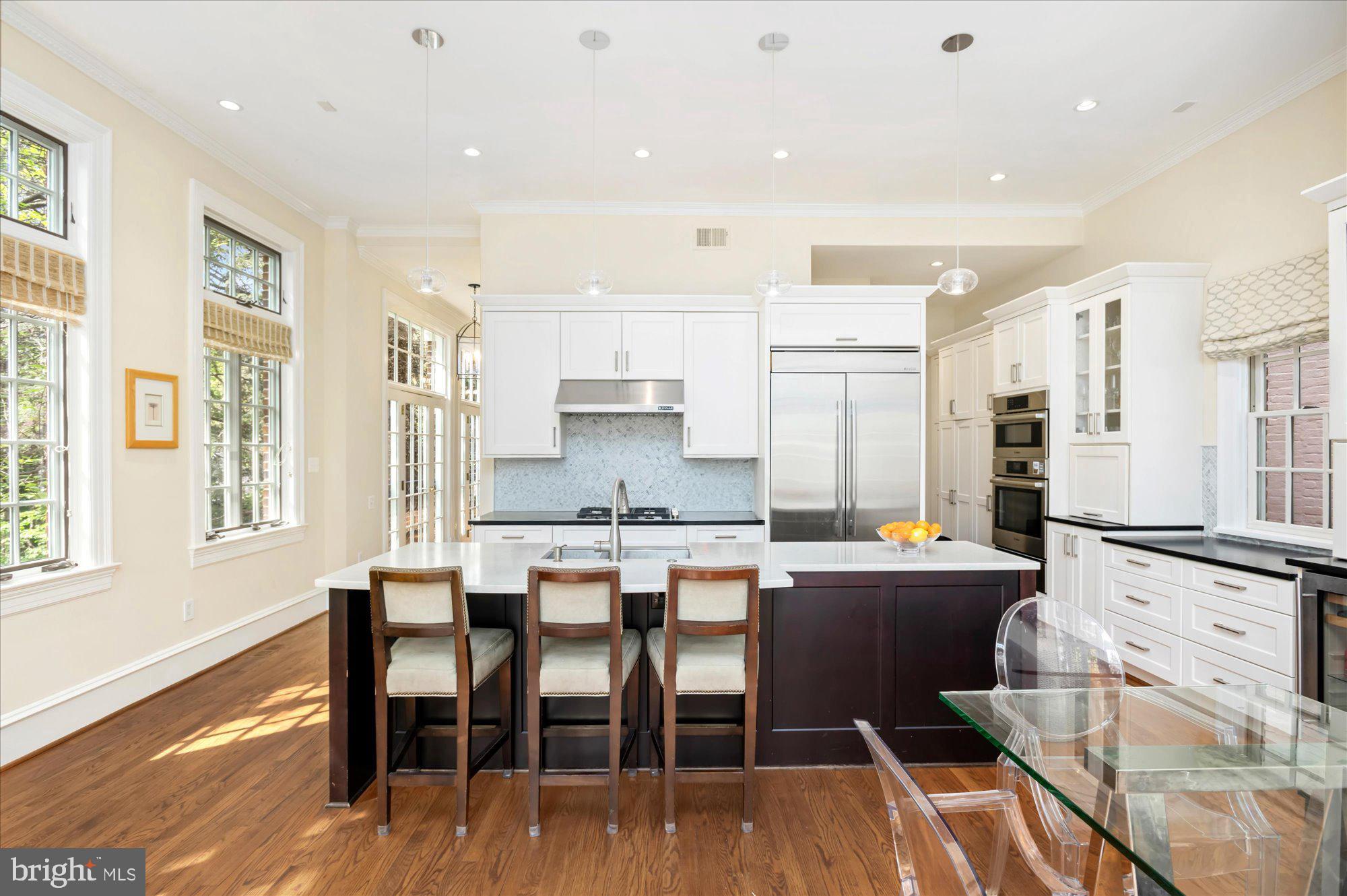 2238 Q Street Northwest Washington, DC 20008 - Photo 10 of 35 a large kitchen with dining table chairs and wooden floor