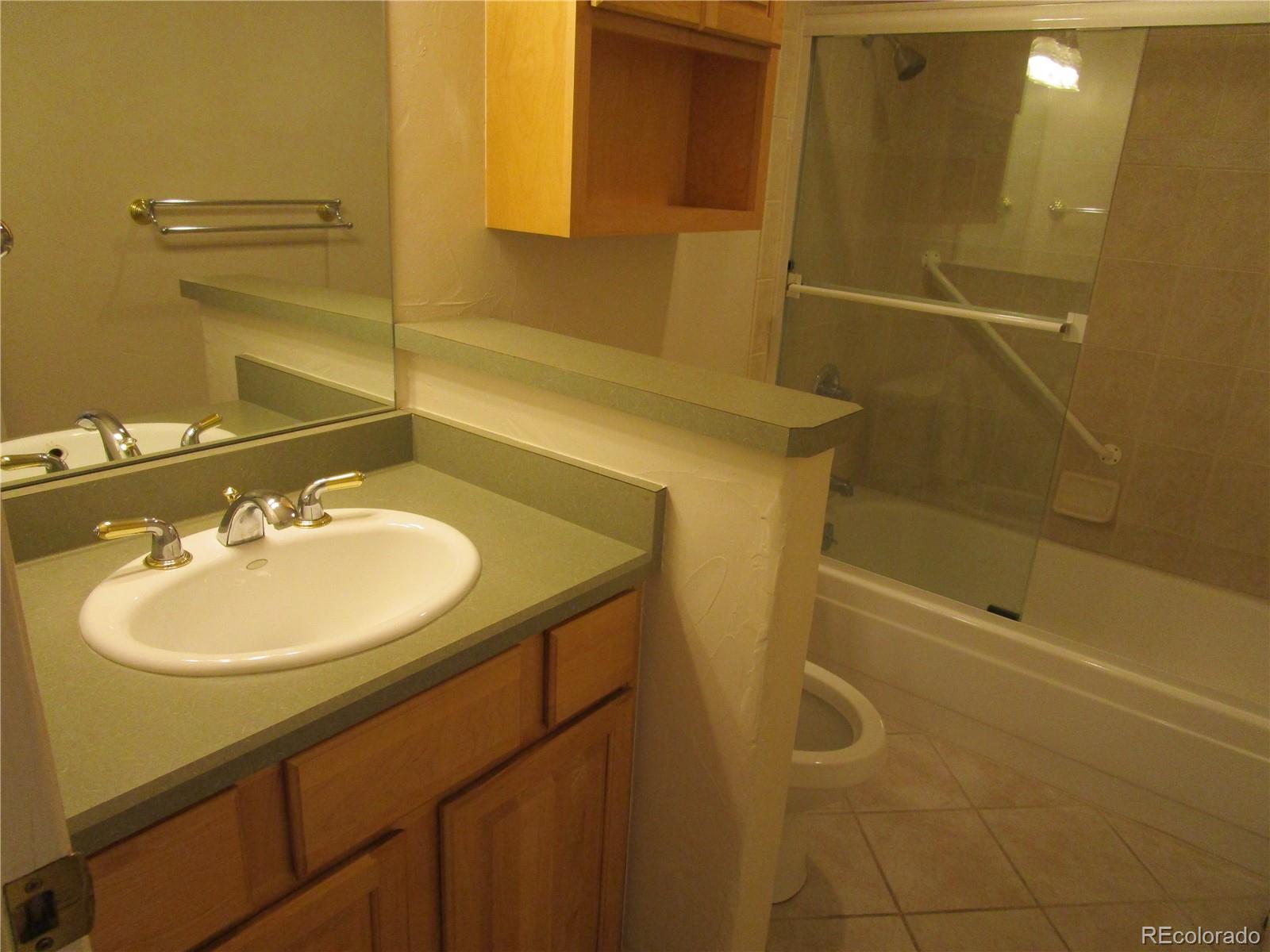 4 Nome Way, Unit A Aurora, CO 80012 - Photo 15 of 22 a bathroom with a sink and a mirror