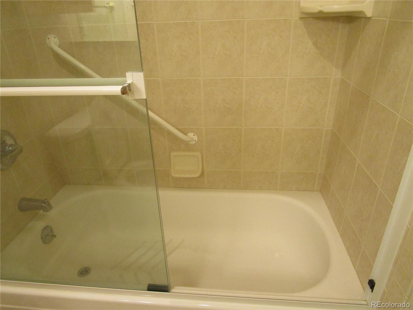 4 Nome Way, Unit A Aurora, CO 80012 - Photo 16 of 22 a bathroom with a bathtub